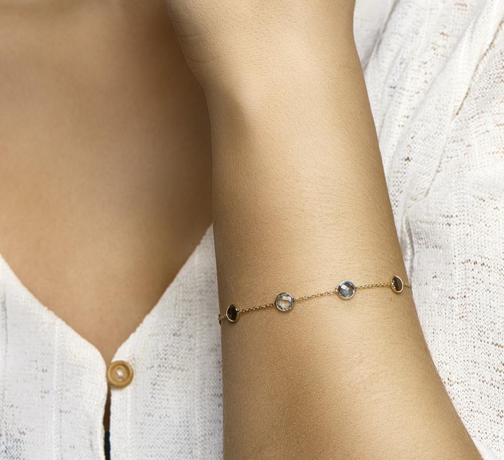 14-karaat-gouden-schakelarmband-met-blauwe-topaas-edelstenen
