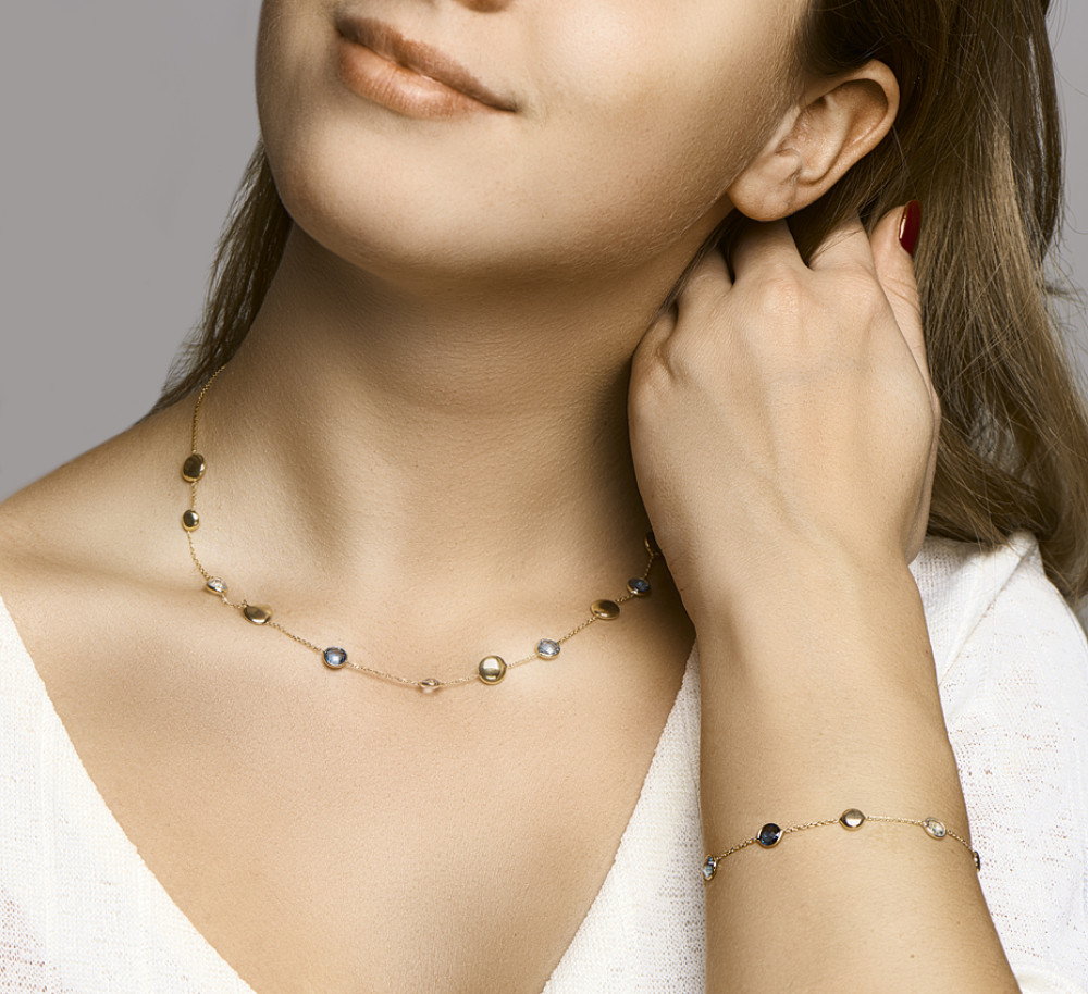 14-karaat-gouden-schakelarmband-met-blauwe-topaas-edelstenen